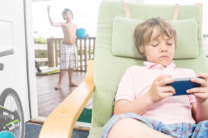 child on screentime with child waiting outside to play